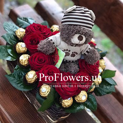Bouquet of flowers and chocolates in the shape of heart